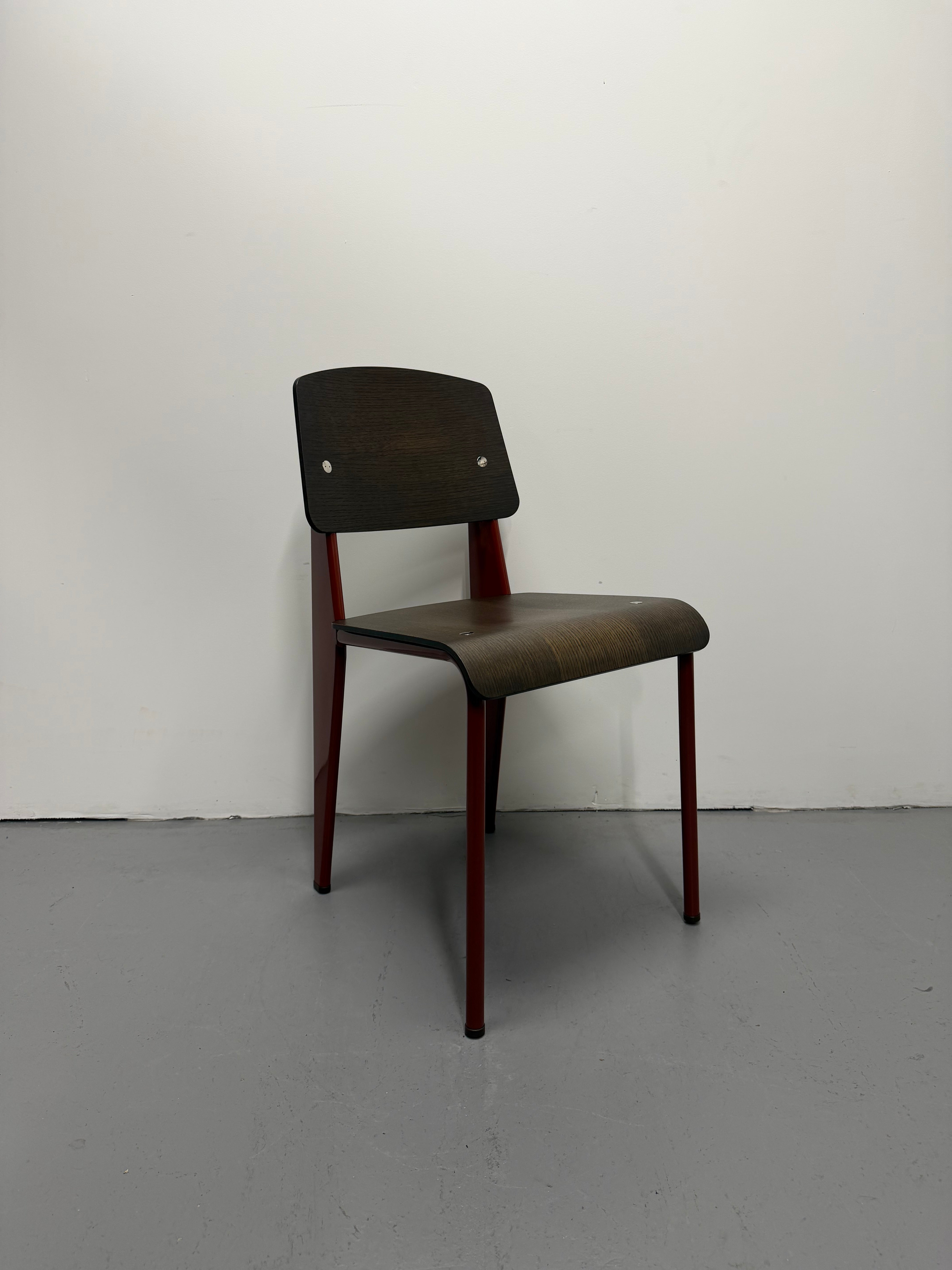 Wooden chair against a white wall