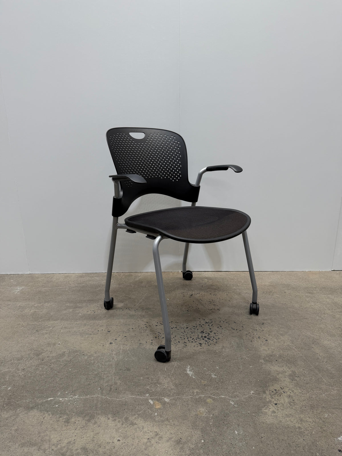 Herman Miller Caper Stacking Chair – Black Flexnet Seat, Fixed Arms, Castors – view 2 – pre-owned