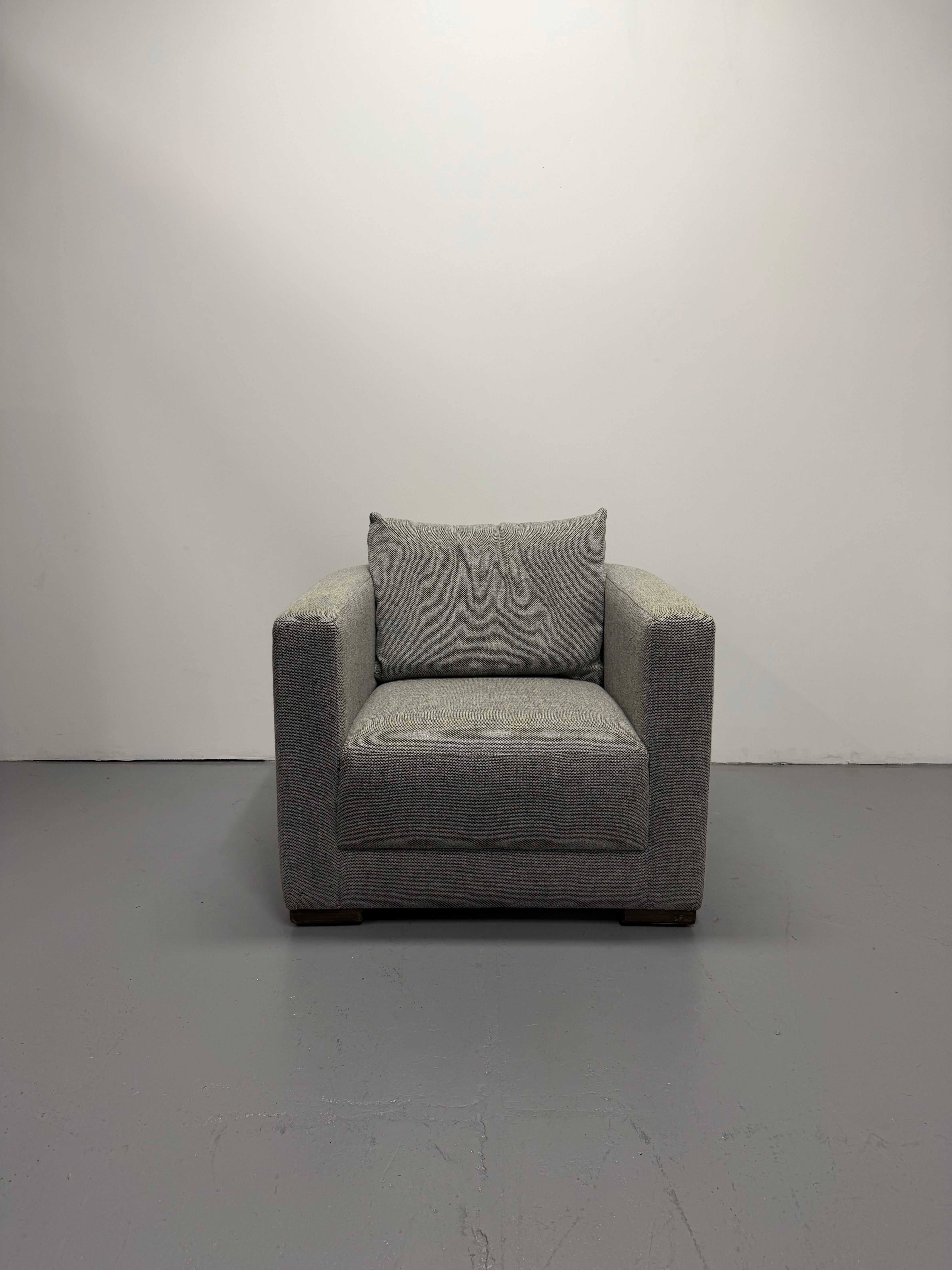 Gray corner sofa against a plain wall