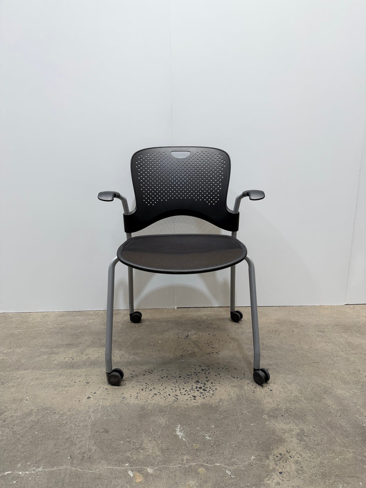 Herman Miller Caper Stacking Chair – Black Flexnet Seat, Fixed Arms, Castors – view 1 – pre-owned